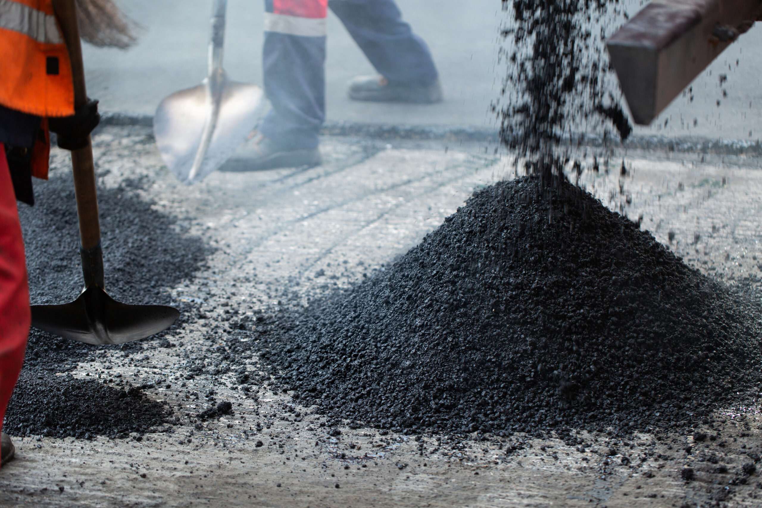 Repair of roads, highways and sidewalks. Patching. Working with a shovel falls asleep in the pit.