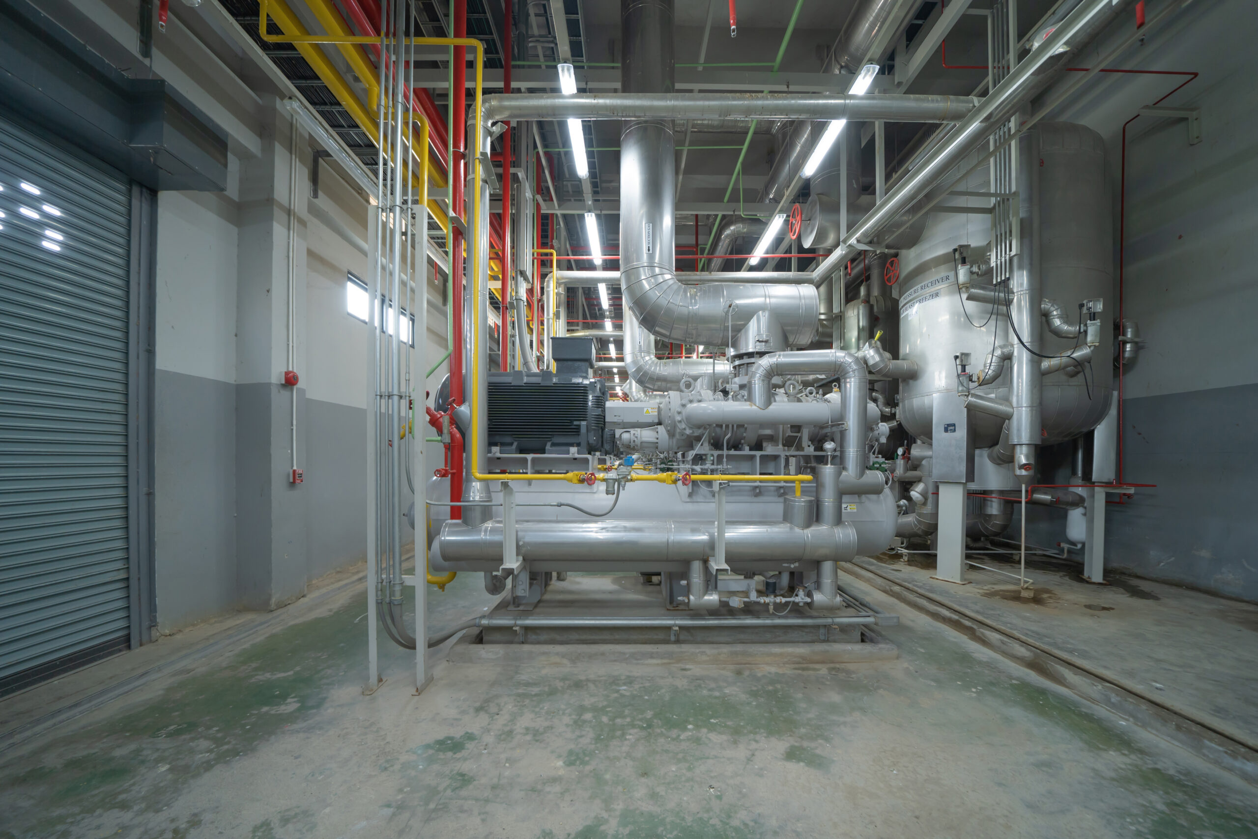 Inside of Industry factory. Chiller tower or cooling tower in building. System work machine. Condenser Water Supply and return pipe lines. Ventilation compressor. Water system in workshop.