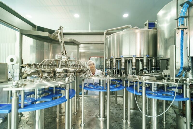 Workers operate machinery in a beverage production 2026 01 09 10 25 11 utc