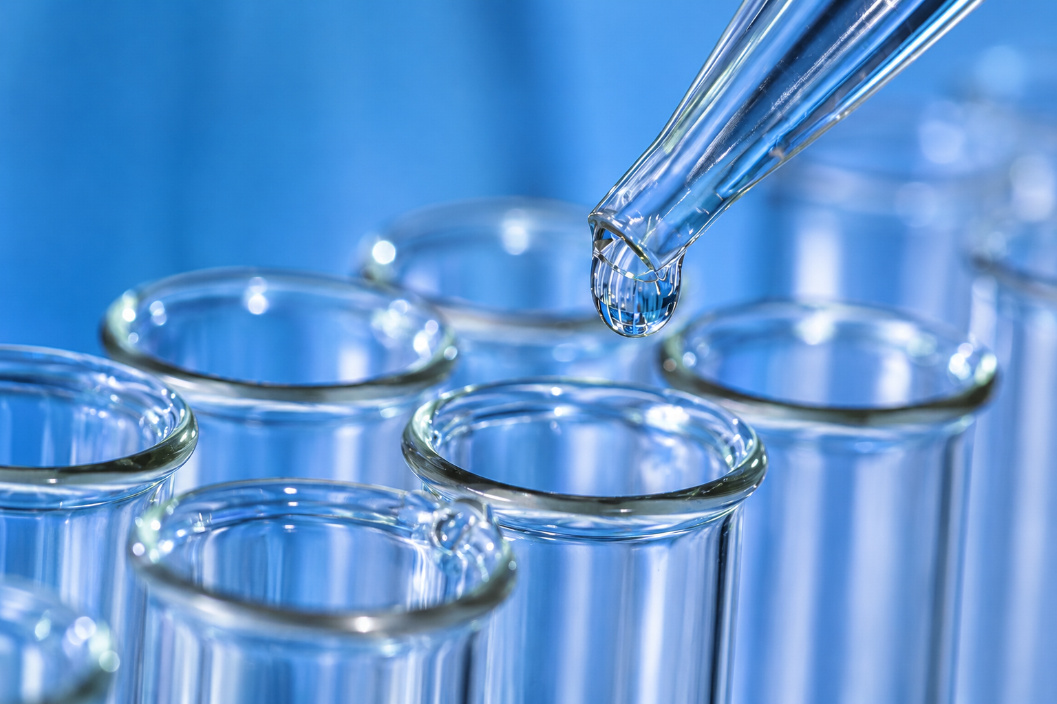 Clear droplets and glass laboratory tools